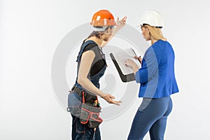 Two woman architecture look in plan and discussing the problems of building on white background