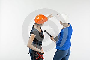 Two woman architecture look in plan and discussing the problems of building on white background