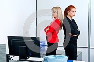 Two woman colegues in office angry to each other
