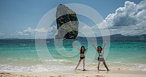 Two woman dancing on the beach