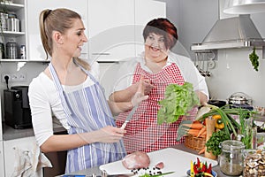 Two woman in the kitchen - one slim, one fat - healthy eating