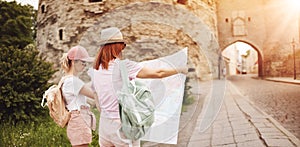 Two woman looking for the location of sights on the map of old Tallinn, Estonia.