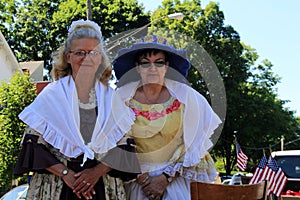 Two woman in period costume, waiting for the holiday parade, Saratoga Springs, New York, 2016