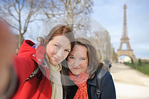 Two woman taking selfie near the Eiffel tower