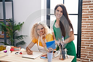 Two women artists using touchpad drawing at art studio