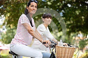 two women on bikes in park