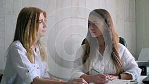 Two women business partner sign a contract. Business concept