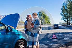 two women calling with broken down car