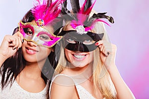 Two women with carnival venetian masks