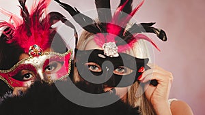 Two women with carnival venetian masks