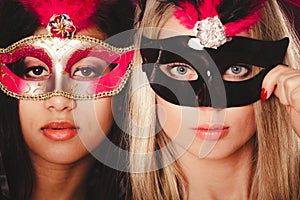 Two women with carnival venetian masks