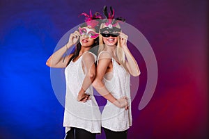 Two women with carnival venetian masks