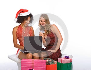 Two women: Christmas online shopping using laptop