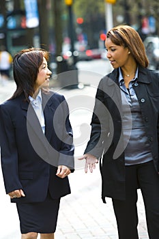 Two women on city sidewalk