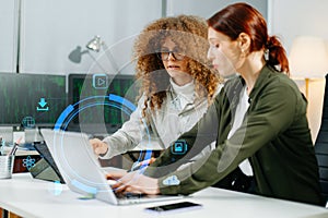 Two women coding together in a high-tech office, showcasing teamwork, software development, and female empowerment