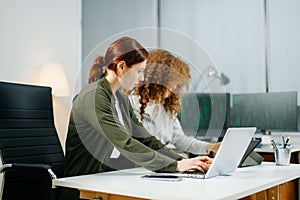 Two women coding together in a high-tech office, showcasing teamwork, software development, and female empowerment