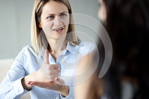 Two women communicate by sign language closeup