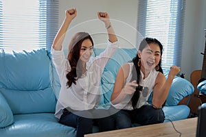 Two women Competitive friends playing video games and excited ha