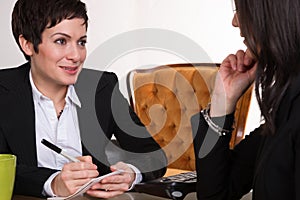 Two Women Conducting Job Interview Computer Desk Office