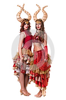 Two women dancers with horns. Isolated on white