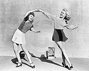 Two women dancing outside