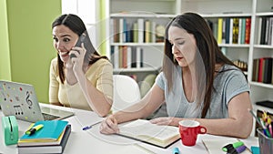 Two women disturbing study for smartphone conversation at library university