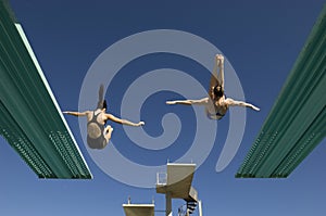 Two Women Diving From Diving Boards