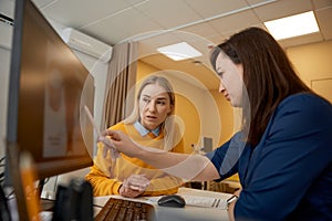 Two women doctor and patient discussing medical KT test results