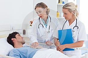 Two women doctors talking to a patient