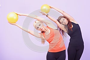 Two women doing Pilates exercise