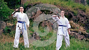 Two women doing synchronised moves with nunchucks