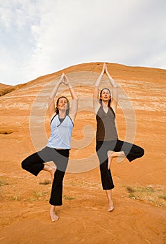 Two Women Doing Yoga Orange Rocks