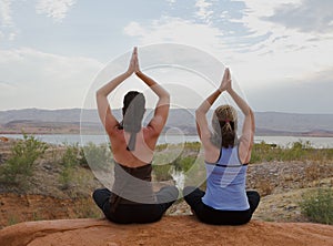 Two Women Doing Yoga at Sunset