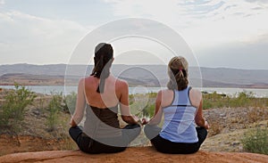 Two Women Doing Yoga at Sunset