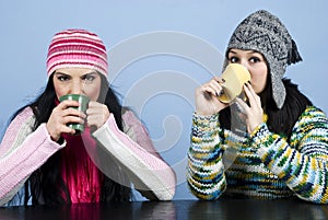 Two women drinking hot drink