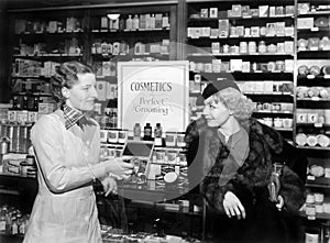 Two women in a drug store looking at each other