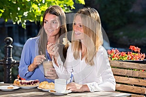 Two women eating in outdoor cafe