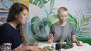 Two women eating in vegetarian restaurants healthy food