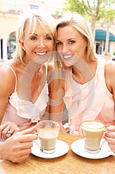 Two Women Enjoying Cup Of Coffee