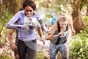 Two women enjoying a run in a forest at an endurance event