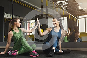 Two women exercising at fitness club