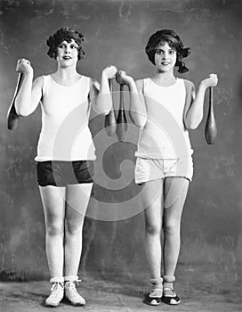 Two women exercising with juggling pins