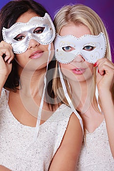 Two women face with carnival venetian masks