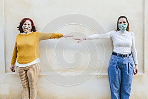 Two women with face masks representing social distancing