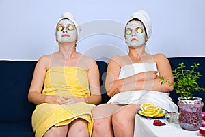 Two women with facial mask at spa