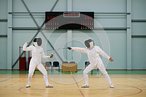 Two women on a fencing training