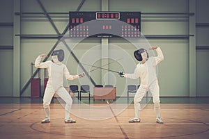 Two women on a fencing training