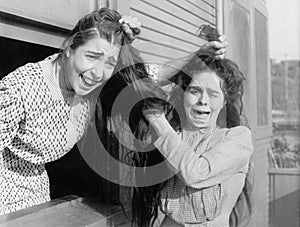 Two women fighting and pulling each others hair