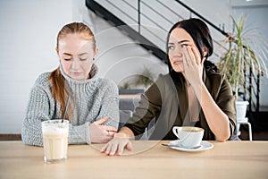 Two women friend sulking at each other, bad relationship concept