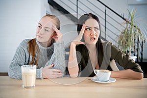Two women friend sulking at each other, bad relationship concept